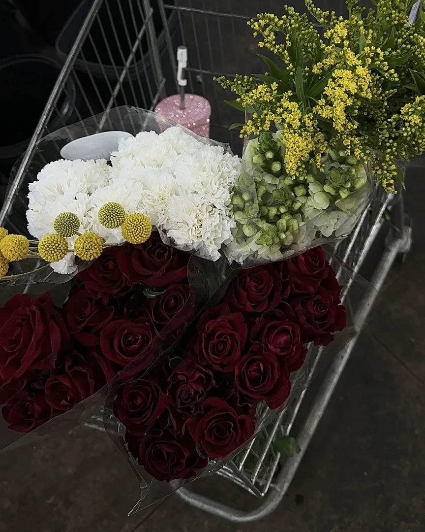 A considered selection of roses, carnations and accent flowers during sourcing for Grace Blooms